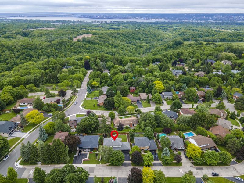 Aerial listing photograph with a pin marking 7 Carl Crescent among tree-lined residential streets