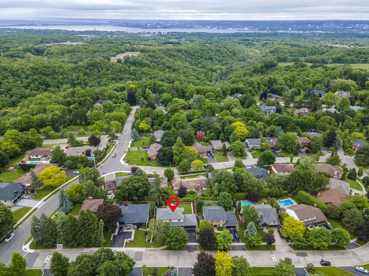 Aerial listing photograph with a pin marking 7 Carl Crescent among tree-lined residential streets